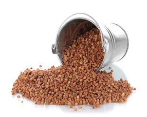 Overturned bucket with grains isolated on white