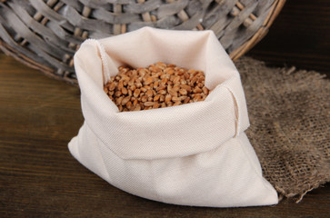 Grains in sack on wooden background