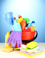 Cleaning items in bucket on  color background