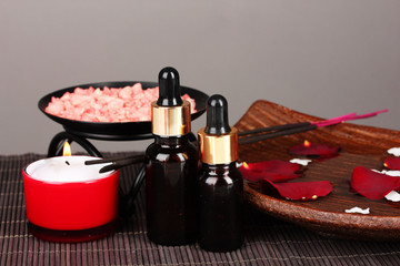 Spa composition with aroma oils on table on gray background