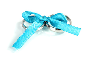 Wedding rings tied with ribbon isolated on white