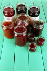 Tasty jam in banks on table
