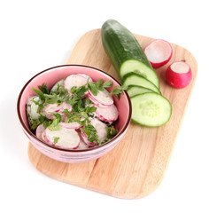 Vitamin vegetable salad in bowl with ingredients isolated