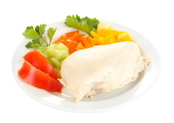 Fototapeta na wymiar Boiled chicken breast on plate with vegetables close up