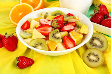 Useful fruit salad of fresh fruits and berries in bowl