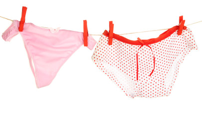 Women's panties hanging on rope isolated on white