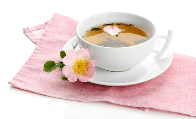Cup of herbal tea with hip rose flowers, isolated on white
