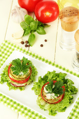 Tasty roasted marrow and tomato slices with salad leaves,
