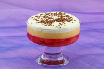 English strawberry trifle in sundae glass on purple background