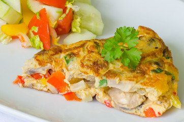 Vegetable omelet with salad on the background