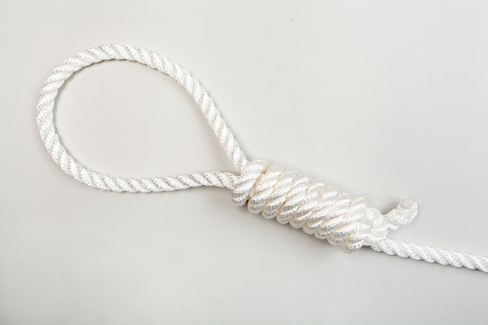Nylon rope with hangman knot on a grey background