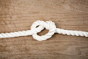 Nylon rope knot on a wooden background