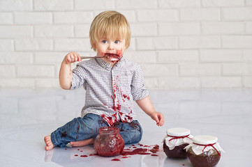 Cute little boy got messy eating strawberry