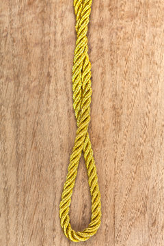 Golden rope on wooden background