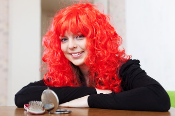 Smiling woman in red wig