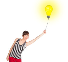 Happy woman holding a light bulb balloon
