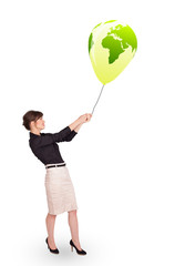 Happy lady holding a green globe balloon