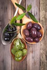 Several olives on wooden ground