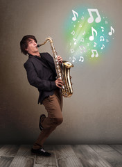 Fototapeta na wymiar Young musician playing on saxophone while musical notes explodin