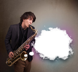 Obraz na płótnie Canvas Young man playing on saxophone with copy space in white cloud