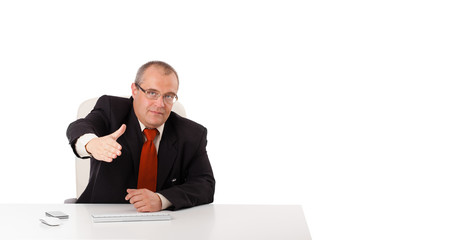 businessman sitting at desk with copy space
