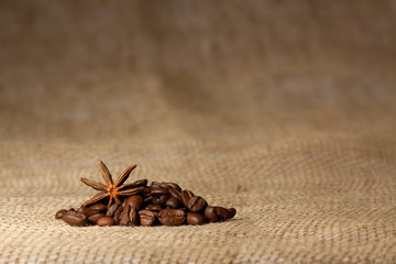 Coffee and Star Anise on sackcloth background with copyspace