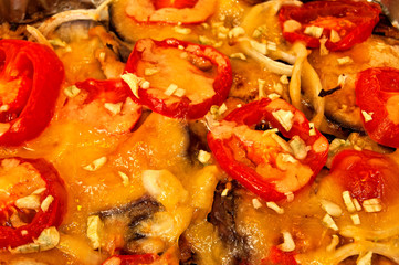 baked aubergine with tomatoes and cheese close up