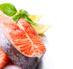 Raw Salmon Red Fish Steak with Herbs and Lemon isolated on White
