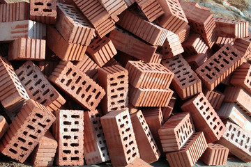 Heap of red ceramic hollow bricks