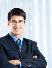 Happy smiling businessman at office