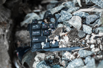broken black keyboard on the trash