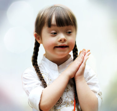 Portrait of beautiful young girl on the praying