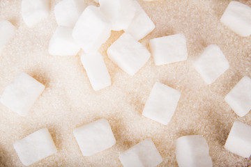 White sugar cubes and crystal sugar