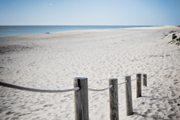 Wooden footpath through dunes at the ocean beach in Portugal