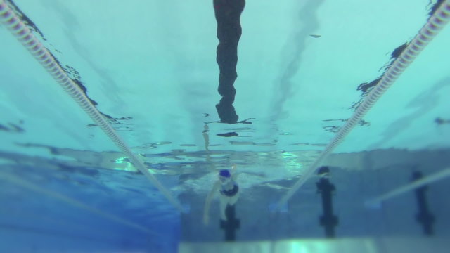 HD - Woman floats in swimming pool