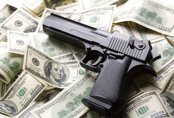 Heap of money and handgun