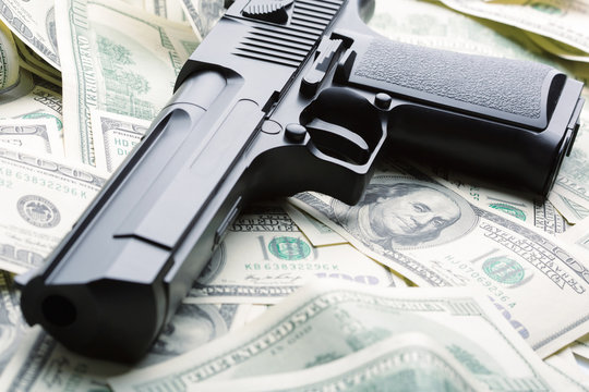 Heap of money and handgun