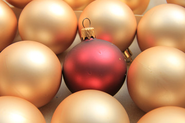 Red ornament on a pile of golden ornaments