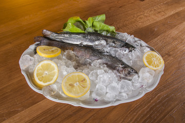 Raw fish on the plate and light background