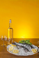 Raw fish on the plate and light background