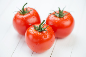 Close-up of three red ripe tomatoes, studio shot