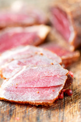 Naklejka premium Slices of cured meet and pepper on table close up