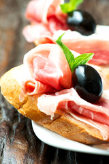 Sandwiches with prosciutto olive on plate