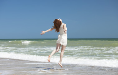 Redhead girl on the beack in spring time