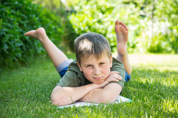 boy with a book on the grass