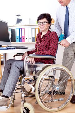 Woman in wheelchair can help in Office