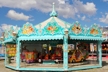 Cyan and white carousel in amusement park