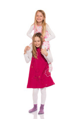 Young girl giving piggyback ride