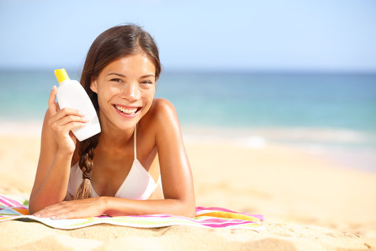 Sunscreen Woman Showing Suntan Lotion Bottle