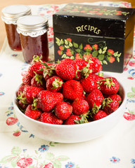 Bowl of strawberries with jam and recipe box